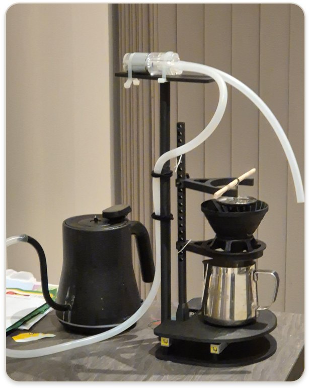 FlowR v2: kettle, pump and dosing arm over a pour-over cone.